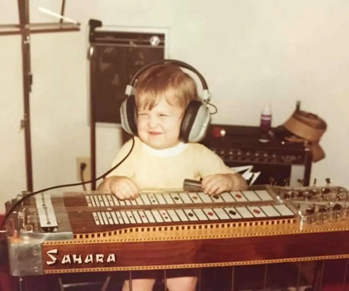 Jeremy as a little boy behind his grandfather's steel guitar