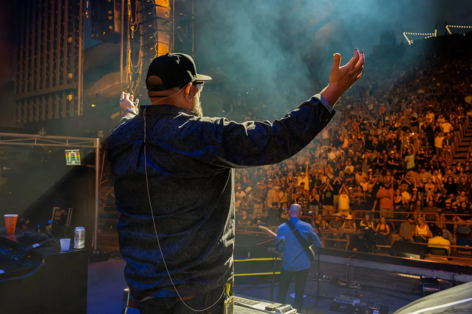 Jeremy Moyers onstage facing a large concert crowd
